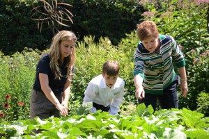 (L to R) U.S. Department of Agriculture (USDA) Agricultural Marketing Service (AMS) Peoples Garden Initiative and Farmers Market Program Manager Annie Ceccarini, Nicholas Come (9), and Agriculture Deputy Secretary Krysta Harden tour USDA’s Peoples Garden on Thursday, Jul. 17, 2014. Nicholas Come (9) from Sacramento, CA launched his own mobile app and social platform called “Nicholas’ Garden” in 2012. Nicholas is a self-proclaimed "Picky Eater" and decided to develop an entirely new, digital business model to support healthier living and fight childhood obesity. His idea stemmed from his passion for growing and serving healthy food and he also wanted to develop a mobile app where his friends and their friends can find and share recipes "By Kids; For Kids". USDA photo by Tom Witham.